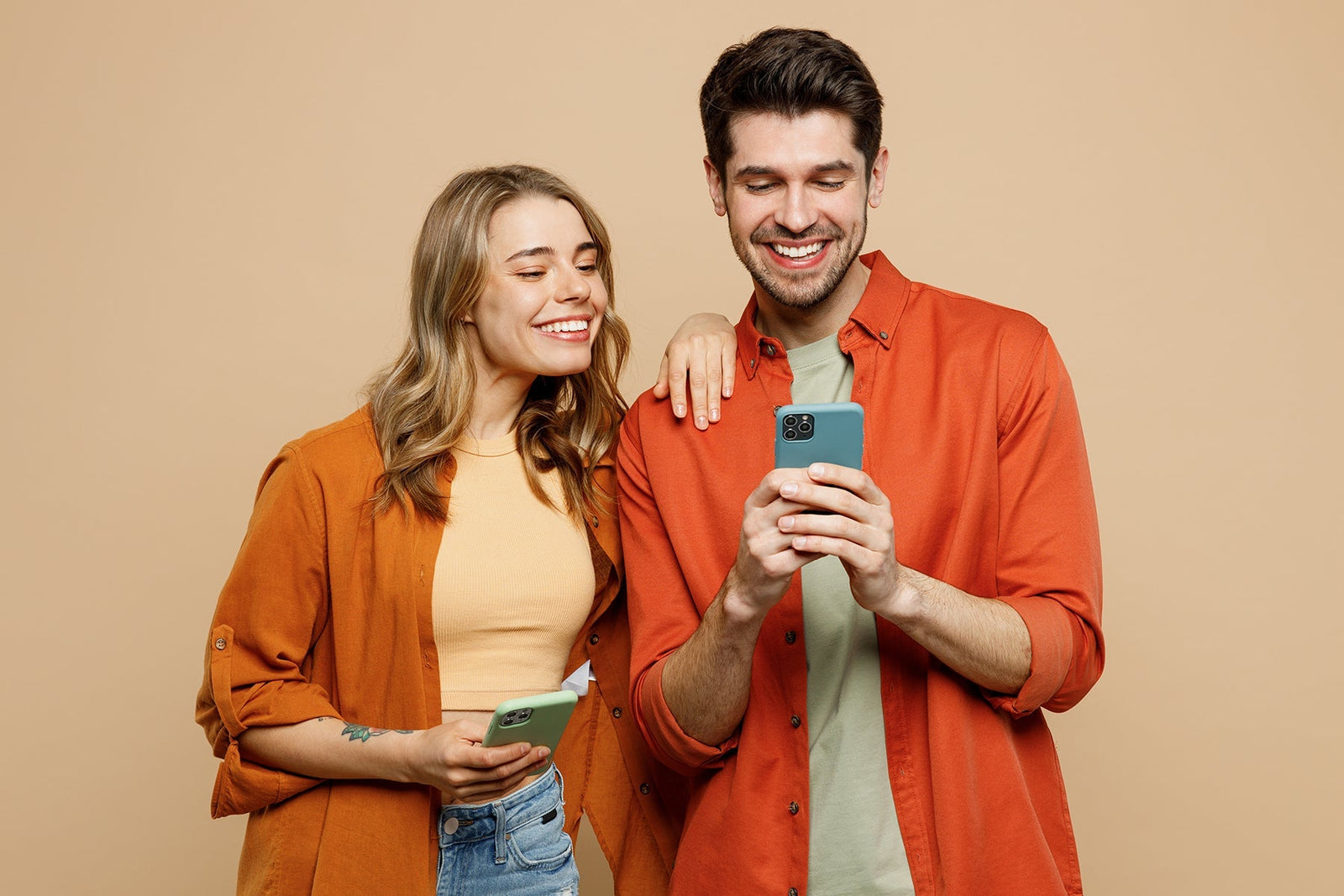 A happy woman and man texting a review