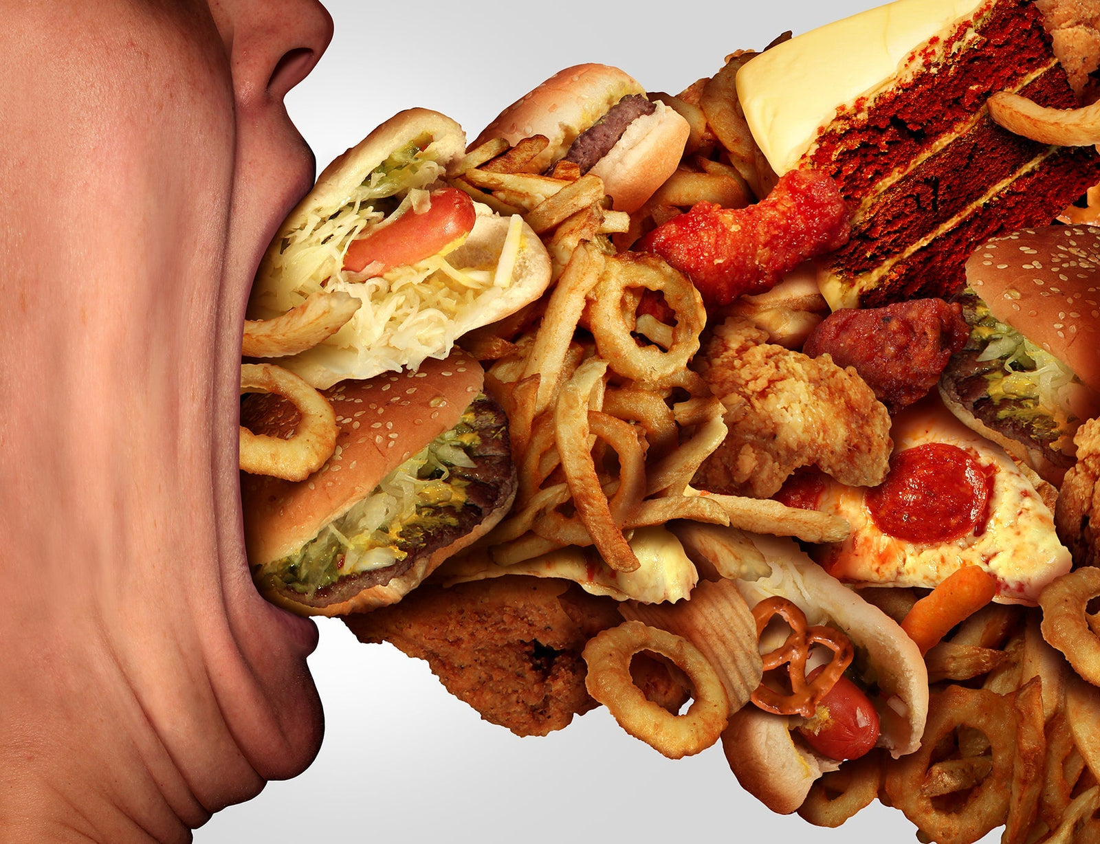 A person shoving junk food in their mouth