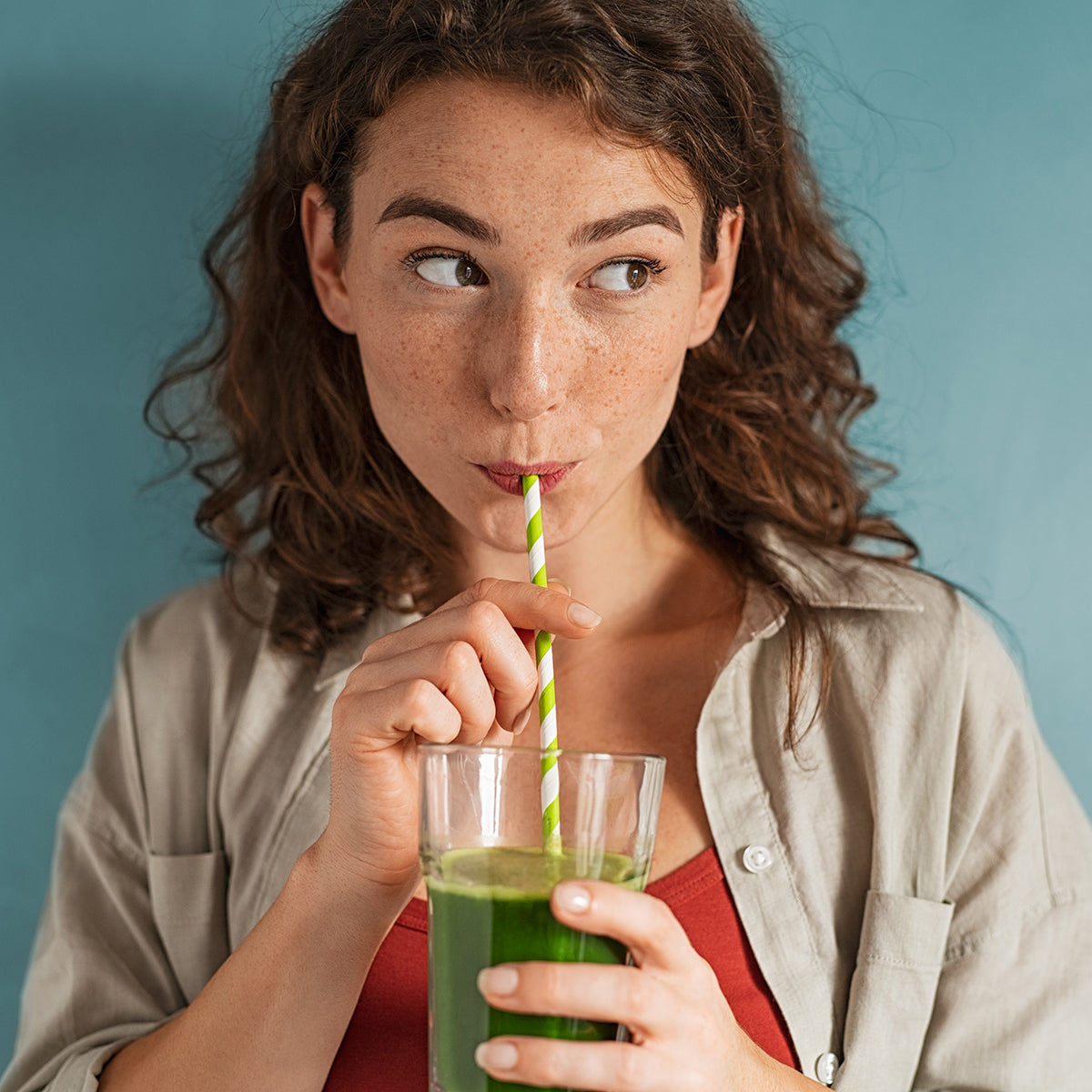 A woman drinking a detox drink