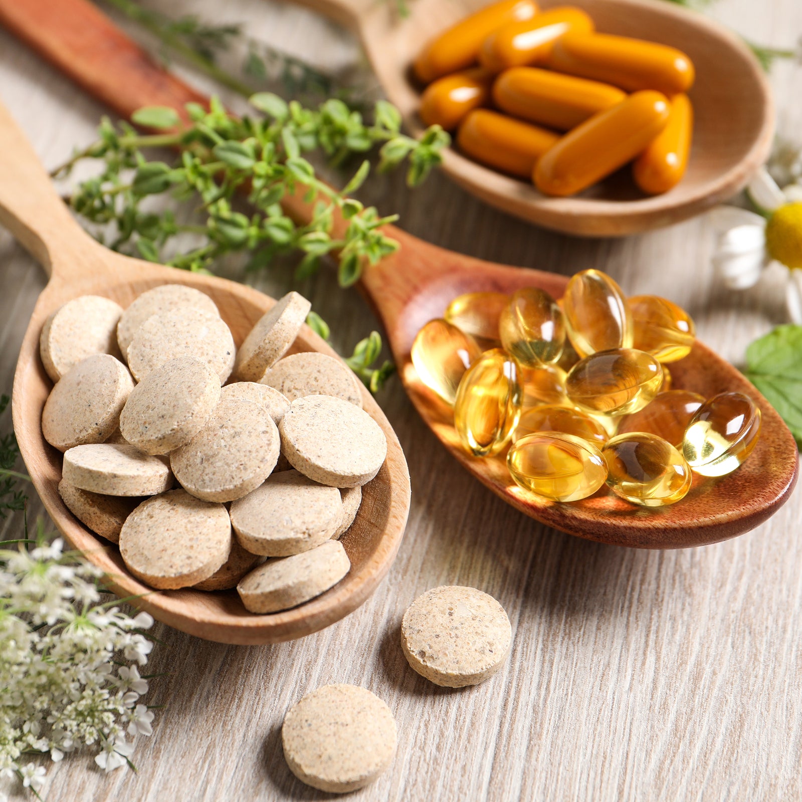 Three wooden spoons with supplements in them